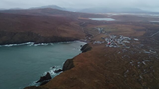 Panning drone shot of the high cliffs and coastline around Aird Uig on Lewis.