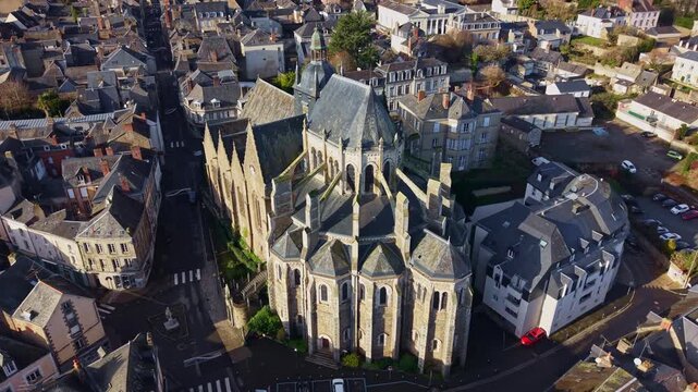 Basilica of Notre Dame of Miracles, cityscape of Mayenne in France. Aerial drone ascending tilt down