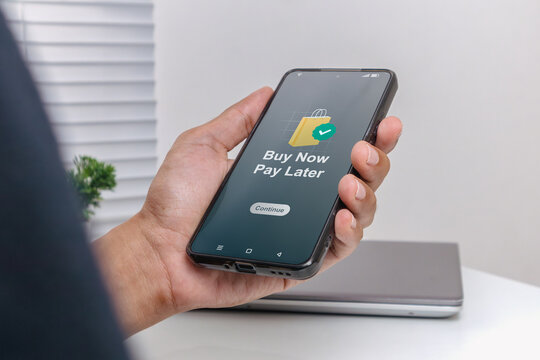 A man using smartphone for online shopping with payment later. Buy now pay later online shopping concept. BNPL.