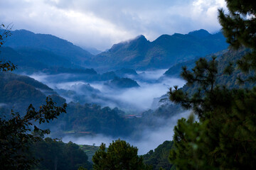 misty morning in mountain landscape with clouds