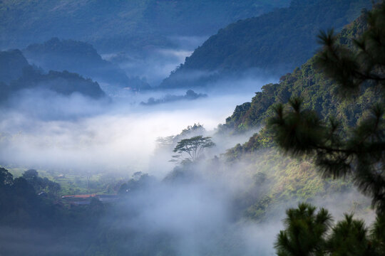 misty morning in mountain landscape with clouds