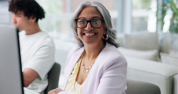 Face, glasses and smile of designer woman in coworking office for research or web development. Computer, creative and happy with mature employee at desk in artistic workplace for digital design