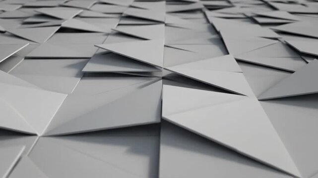 Abstract geometric surface with triangular facets in gray tones