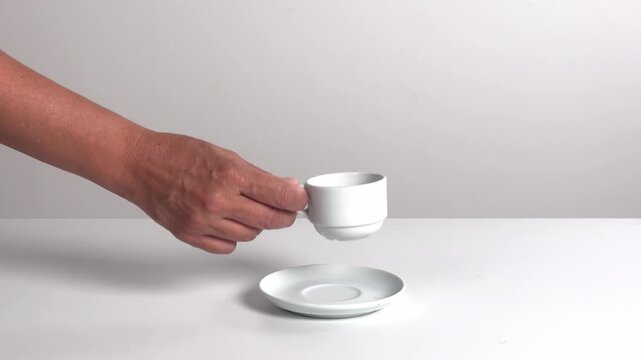 Video with real sound effect of Ceramic cup set down on ceramic saucer