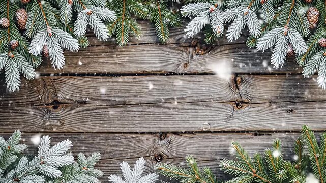 Christmas Fir Branches with Snowflakes on Rustic Wooden Background for Festive Greetings