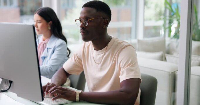 Man, typing and serious with computer, office or journalist with research for article and coworking. Newsroom, people and creative with tech for story, editing and reporter with glasses for draft