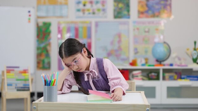 Tired Schoolgirl with Glasses Struggling to Study in Classroom
