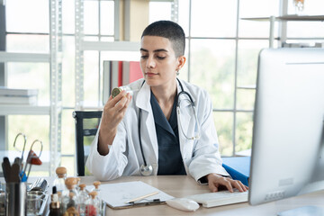 Female doctor working with holding pill in clinic