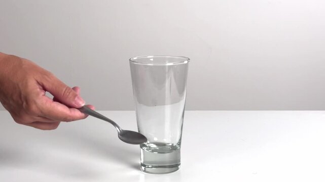 Video with real sound effect of Metal spoon tapping glass