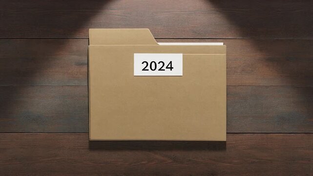 Labeled Manilla Folder. Tax Preparation Desk Setup. A generic manilla folder with a neat generic label reading '2024 TAXES' resting on a rustic textured wooden floor.
