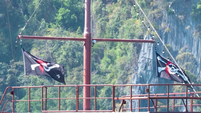 Pirate Jolly Roger Flags Waving on Ship in Phi Phi Islands