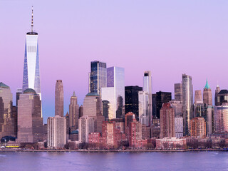 Obraz premium New York City at dusk. Manhattan skyscrapers at sunset. New York City panorama view. Manhattan panoramic skyscrapers at dusk. Manhattan skyline waterfront. New York City skyline.