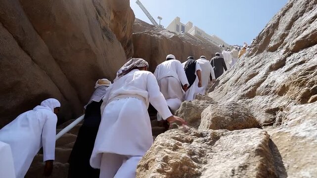 Ground view of Mount Arafat with pilgrims climbing rocky hill Makkah Saudi Arabia Hajj ritual location spir (3)