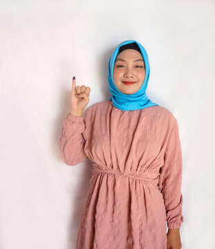 Young Girl Showing Little Finger Dipped In Ink After Voting For The President And Government Election In Indonesia