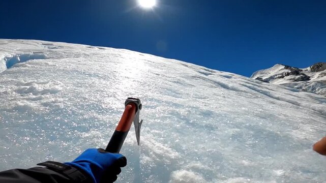 First Person View of Hands Holding Ice Axes on a Glacier