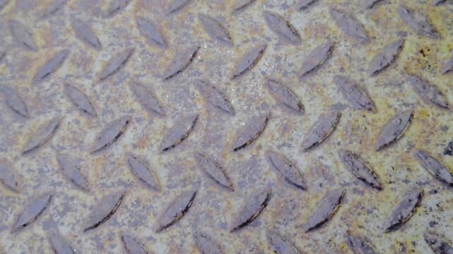 Weathered metallic surface with fine scratches and industrial debris found on a diamond plate floor in Zuglo Budapest. High-resolution texture for realistic 2026 digital environment and VR design.