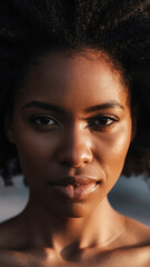 Close-up portrait of a woman with natural hair and smooth skin.