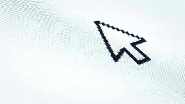 Macro view of a black pixelated cursor arrow on a bright white computer screen, representing digital interface interaction and technology.