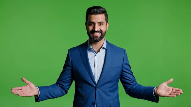 Confident man explaining presentation in blue suit against green backdrop