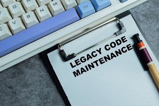 Concept of legal code maintenance write on clipboard isolated on Wooden Table. For software system, technical debt and software refactoring challenges