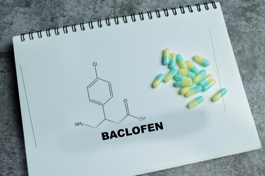 Concept of baclofen muscle relaxant write on book with closed stamp isolated on Wooden Table. For spasticity and neurological