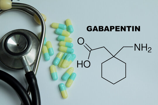 Concept of gabapentin write on book with isolated on Wooden Table. For neurological conditions, pain management and healthcare