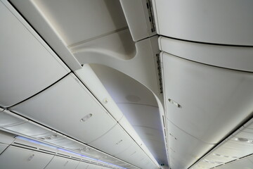 Fototapeta premium Airplane cabin ceiling and overhead bins.