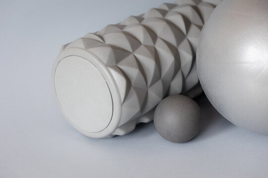gray solid background for sports and fitness with copy space. mfr roll and massage ball for training