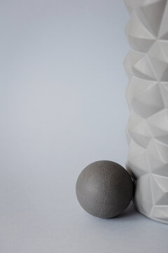 gray solid background for sports and fitness with copy space. mfr roll and massage ball for training
