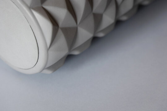 gray solid background for sports and fitness with copy space. mfr roll and massage ball for training