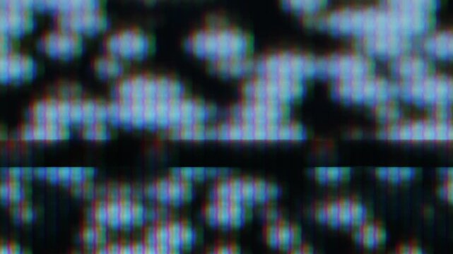 Analog TV screen close-up with static pixels. Blurry image.