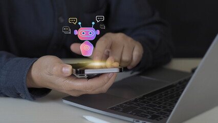I technology and virtual assistant concept showing businessman using mobile phone with chatbot interface for customer service automation and digital communication innovation in modern business.