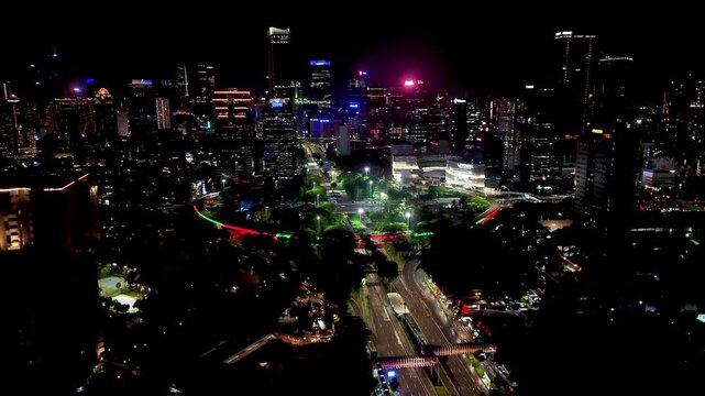 Jakarta, Indonesia, Dec 31, 2025 : Night cityscape of Jakarta near the Semanggi area, featuring tall buildings, glowing city lights, and busy urban roads.