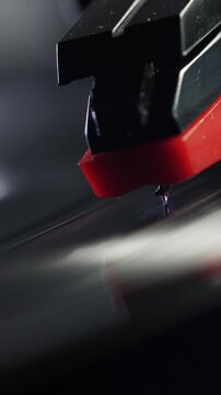 Close-up of needle on vinyl record. Vertical video.