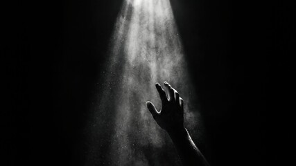 Obraz premium Ethereal Light Beam Illuminating a Reaching Hand in Dark Space with Soft Particles Effect