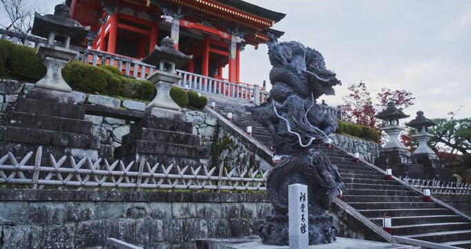 Slow movement in on stone steps of ancient Japanese shrine and statues