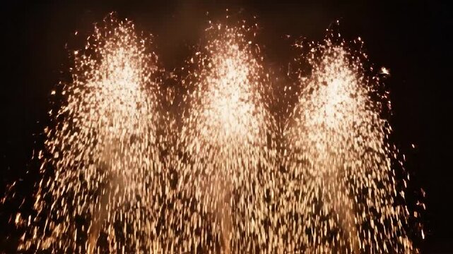 Four streams of sparks ascending in darkness, creating a spectacle of light and color