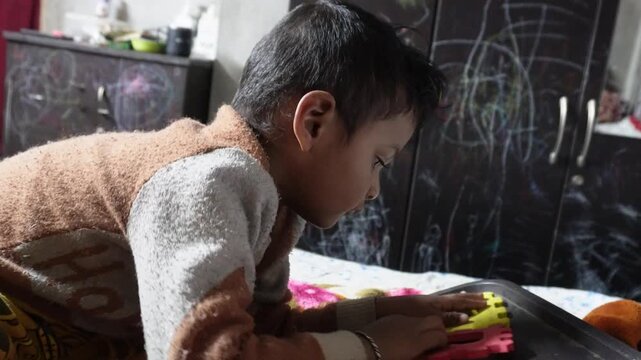Child Playing with Colorful Interlocking Foam Alphabet Blocks