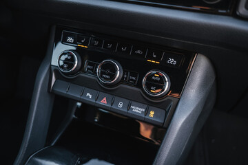 Modern interior of a family SUV, leather steering wheel, sports leather seats, large navigation screen. Interior details.