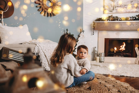 Winter Cabin set up with siblings playing by fireplace.