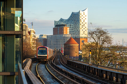 Hamburg train approaching Elbphilharmonie on elevated urban railway