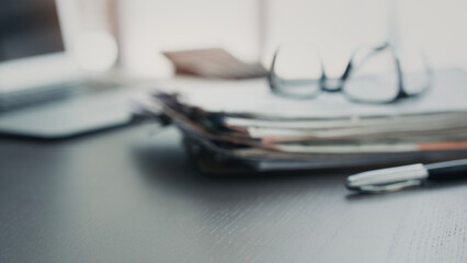 Blurred office desk with laptop and documents