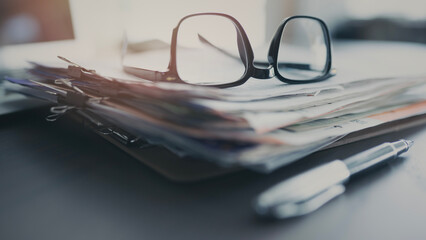 Office desk with laptop and documents