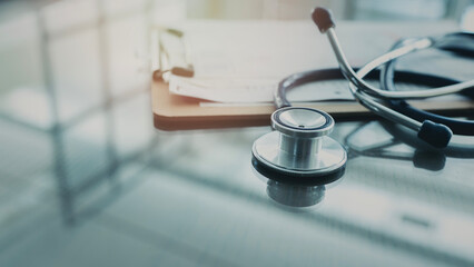 Medical data and stethoscope on table