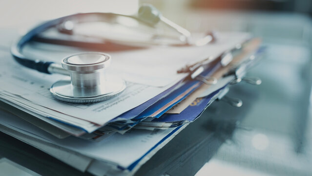 Medical data and stethoscope on table