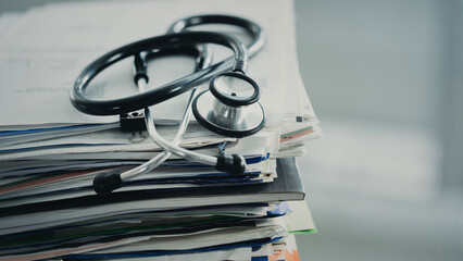 Medical data and stethoscope on table