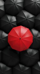 A Red Umbrella Standing Out from the Crowd of Black Umbrellas in a Unique Perspective