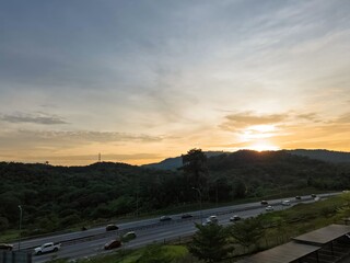 Fototapeta premium Sunrise near the highway in Malaysia, viewed from an apartment.