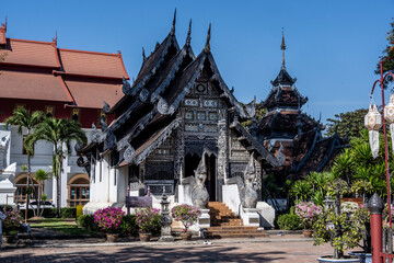 Separate fragments of a decorated Buddhist temple in Thailand on a sunny day