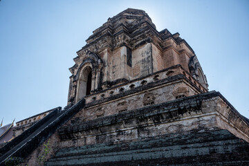 Separate fragments of a decorated Buddhist temple in Thailand on a sunny day